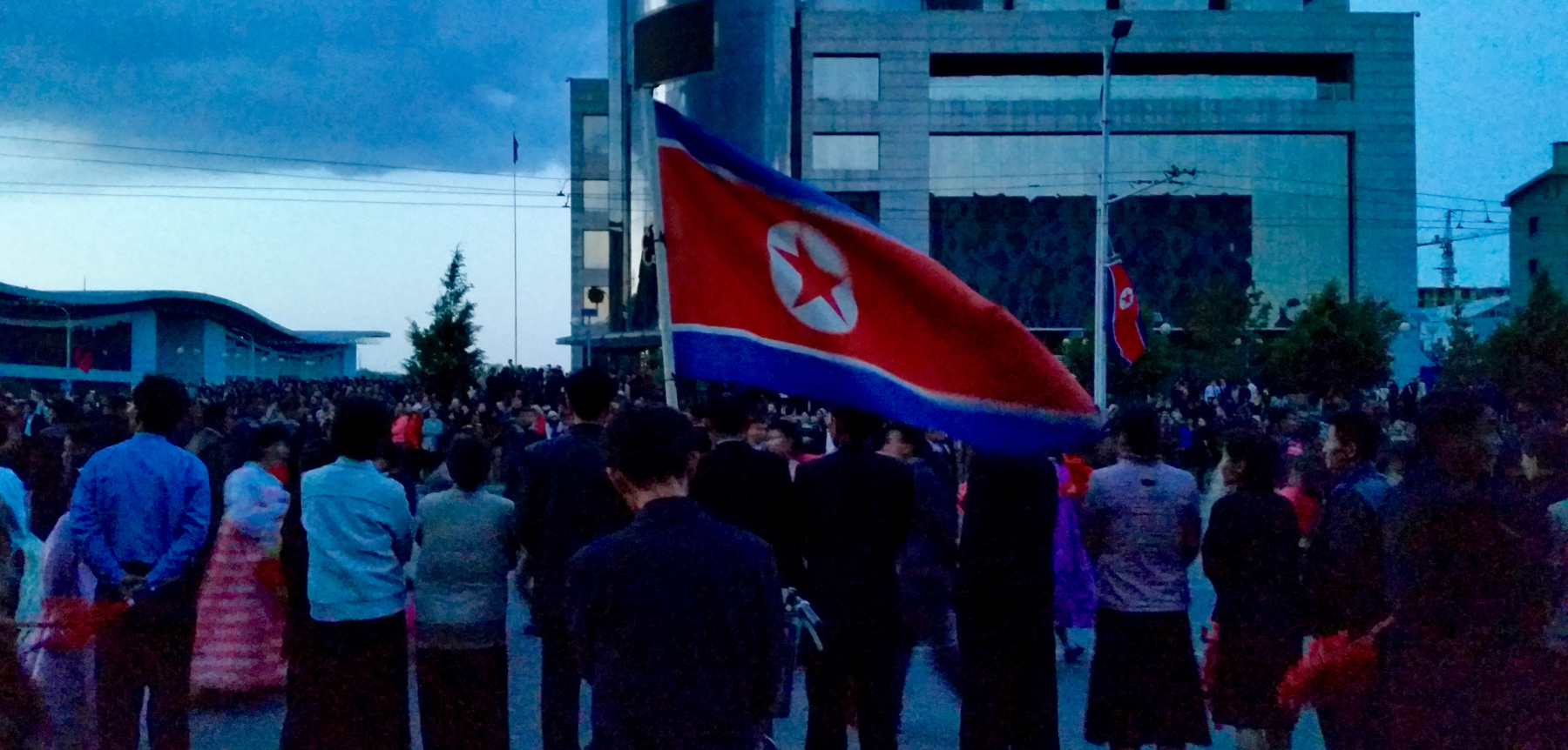 This is one of the last photos I could take that night before it got too dark. Many people were carrying large flags like this on flagpoles, and waving them around.